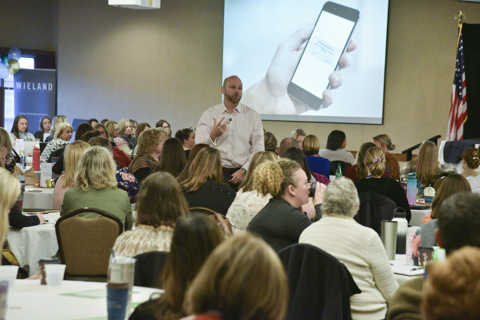 Eric Papp walking through the audience during an interactive leadership keynote